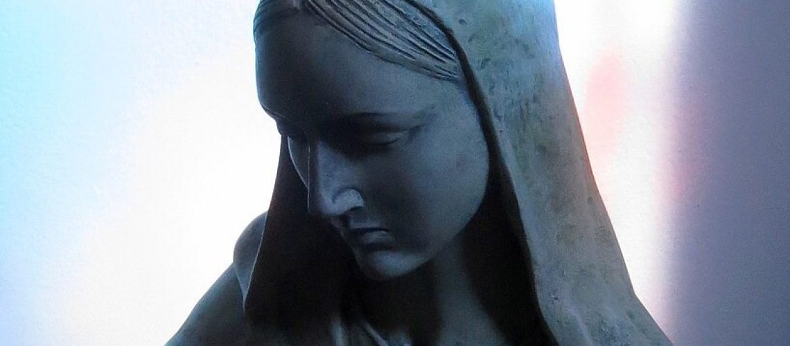 Saint_Peter_Catholic_Church_(Millersburg,_Ohio)_-_statue_of_the_Virgin_Mary_in_a_stained_glass_window_shadow