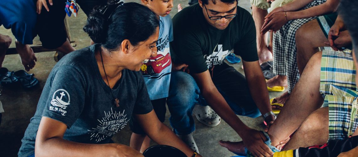 The Martins Family washing the feet of prisoners in the Philippines