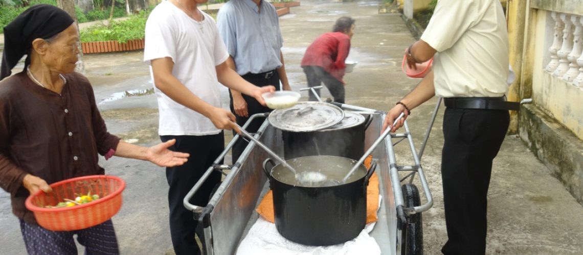 Three friars serving a meal.
