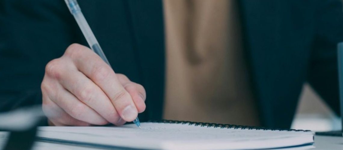 free-photo-of-close-up-of-person-writing-in-notebook