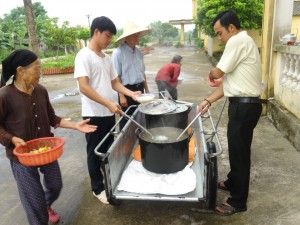 Three friars serving a meal at Van Mon.